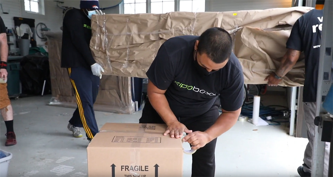 Zippboxx crew members packing customer items